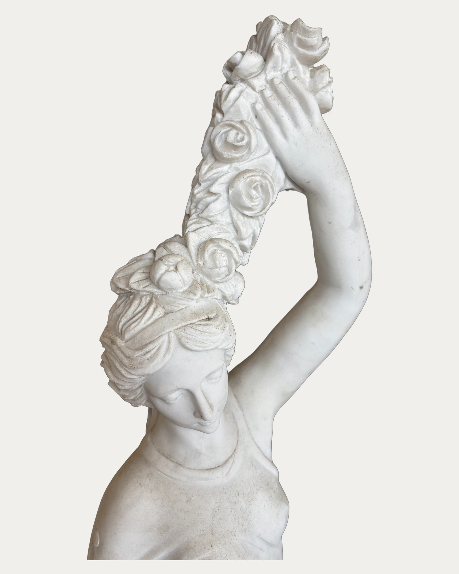 Woman with Raised Floral Garland Statue, carving and surface detail 1